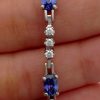 A person holding a 3.50 Ct Unheated Sapphire and 0.72 Ct Diamond Cocktail Tennis Bracelet 14k