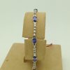 3.50 Ct Unheated Sapphire and 0.72 Ct Diamond Cocktail Tennis Bracelet 14k hanging on a piece of carton