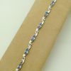 8.25 Ct Tanzanite and 0.16 Ct Diamond Swirl Bracelet 14k on a piece of carton