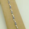 8.25 Ct Tanzanite and 0.16 Ct Diamond Swirl Bracelet 14k on a piece of carton