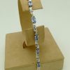 8.25 Ct Tanzanite and 0.16 Ct Diamond Swirl Bracelet 14k on a piece of carton