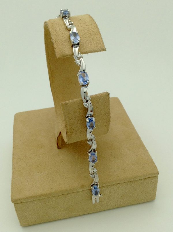8.25 Ct Tanzanite and 0.16 Ct Diamond Swirl Bracelet 14k on a piece of carton