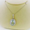 27.00 carat Aquamarine and 2.40 carat Diamond Triple Halo Necklace on a carton neck