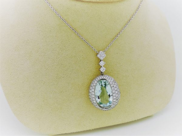27.00 carat Aquamarine and 2.40 carat Diamond Triple Halo Necklace on a carton neck