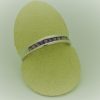 0.25 carat Amethyst Princess Cut Channel with14k Gold Ring on a carton finger