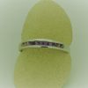 0.25 carat Amethyst Princess Cut Channel with14k Gold Ring on a carton finger