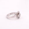 A ring with 1 small heart inside a bigger heart with gemstones