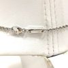 Happy Cross 18K Gold and Diamonds Necklace wrapped around a piece of cloth