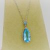 5.00 Ct Blue Topaz with 0.10 Ct Diamond Halo Pendant 14k Includes 14k Chain on a piece of carton