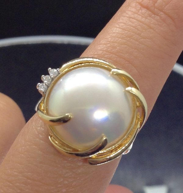 Alluring 13mm Mabe Pearl with 0.03 Ct Diamond Accents 14k Yellow Gold Ring on a real finger (front view)
