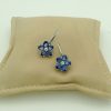 18K White Gold 6 CT Unheated Sapphire Flower Earrings W/ 0.60 CT VS Diamond hanging on a pillow