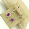 14K White Gold 2.0 CT Pink Sapphire Flower Earrings W/ 1.04 CT VS Diamond Halo hanging on carton