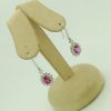 14K White Gold 2.0 CT Pink Sapphire Flower Earrings W/ 1.04 CT VS Diamond Halo hanging on fake ears