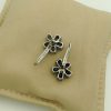 18K White Gold 6 CT Unheated Sapphire Flower Earrings W/ 0.60 CT VS Diamond upside down on a pillow