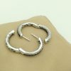 Two opened 18K White Gold 3.00 CT VS Diamond and Blue Sapphire Inside Out Hoops Gorgeous on a pillow
