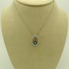 14k white gold diamond and sapphire necklace on a fake carton neck
