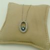 14k white gold diamond and sapphire necklace on a pillow