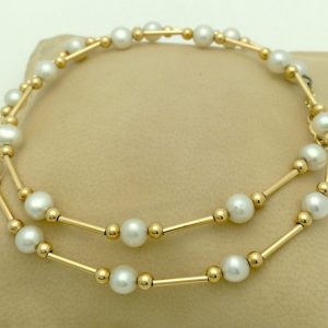 Classy 4mm Akoya Pearls w/ 14k yellow gold beads and bars on a pillow