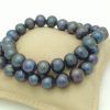 Elegant 12mm Black Tahitian Pearls w/ 14k White Gold Clasp on a pillow