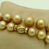 Golden South Sea Pearls 16mm 18k Yellow gold Clasp w/ VS Diamonds accents on a pillow