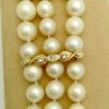 3 Row South Sea Cultured Pearls 8mm 18k Yellow Gold Clasp w/ VS Diamonds accents on a platform