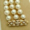 A woman holding 3 Row South Sea Cultured Pearls 8mm 18k Yellow Gold Clasp w/ VS Diamonds accents from close up