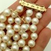 A woman holding 3 Row South Sea Cultured Pearls 8mm 18k Yellow Gold Clasp w/ VS Diamonds accents