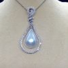 Front view of 18.7 Ct Mabe Pearl with 1.00 Ct Diamond 14k White Gold Pendant with 16" 14k White Gold Chain hanging on a fake neck