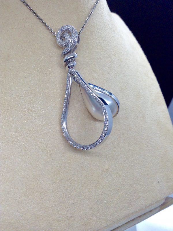 18.7 Ct Mabe Pearl with 1.00 Ct Diamond 14k White Gold Pendant with 16" 14k White Gold Chain hanging on a fake neck