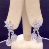 Front view of 7.34 Ct Diamonds with 10mm South Sea Pearls Medium Dangle Platinum Earrings hanging on fake ears