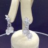 Side view of 7.34 Ct Diamonds with 10mm South Sea Pearls Medium Dangle Platinum Earrings hanging on fake ears